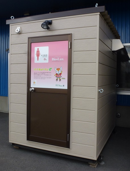 女性専用バイオトイレ。T型。 女性のためのバイオトイレを女性目線で開発したもの。鏡や服かけフック、警報ベルも装備。手洗い器付き。